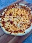 A freshly baked homemade pizza with a golden, crispy crust, melted cheese, and a variety of delicious toppings. The pizza is made with King Arthur Pizza Dough Flour for a light and chewy texture, perfect for family pizza night!