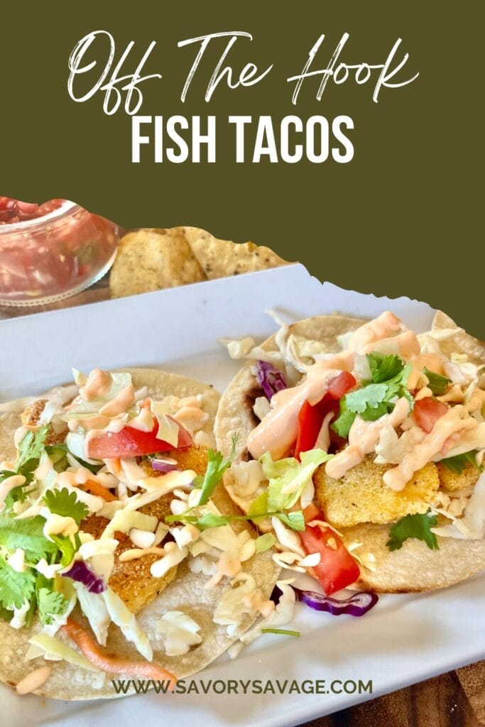 A plate of crispy, golden-brown fish tacos topped with vibrant cabbage slaw, creamy fish taco sauce, and garnished with fresh lime wedges. The tacos are served alongside tortilla chips, guacamole, and a refreshing drink, showcasing a delicious and inviting meal perfect for family dinners or gatherings.